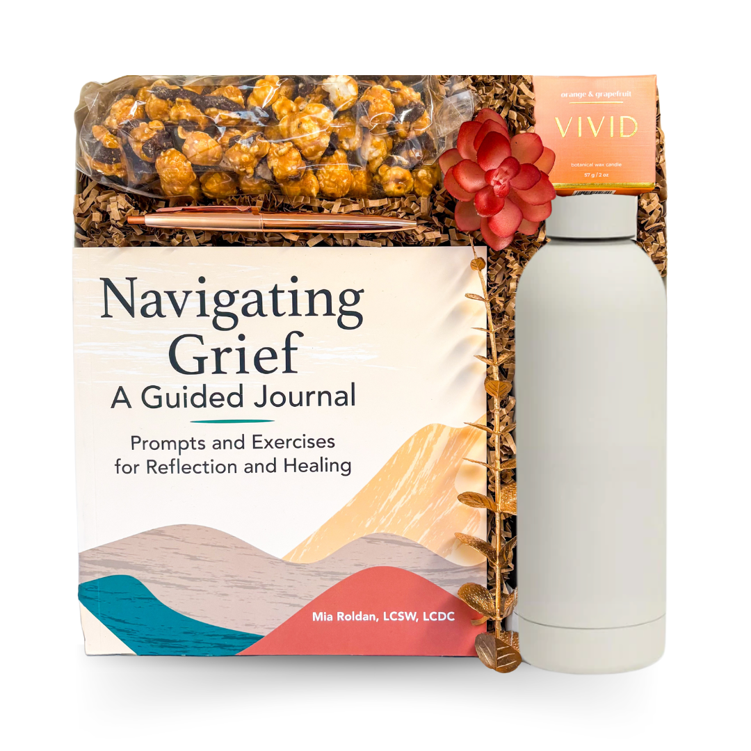With Sympathy comfort gift box featuring a guided grief journal, calming candle, insulated bottle, gourmet snacks, and supportive self-care items curated by Black Bow Gift Co.
