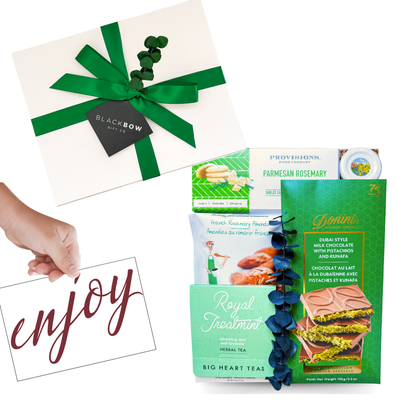 Worldly Delights gourmet gift box styled in green and white, celebrating global-inspired flavors.