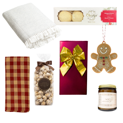 Wrapped in Christmas festive gift box featuring gourmet holiday treats, Belgian chocolates, a seasonal candle, Christmas greenery and a choice of cozy blanket.