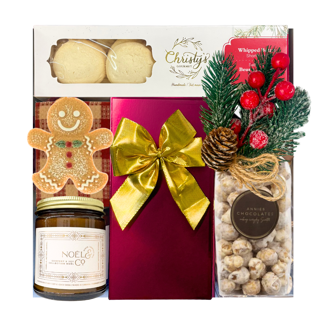 Wrapped in Christmas festive gift box featuring gourmet holiday treats, Belgian chocolates, a seasonal candle, Christmas greenery and a choice of cozy blanket.