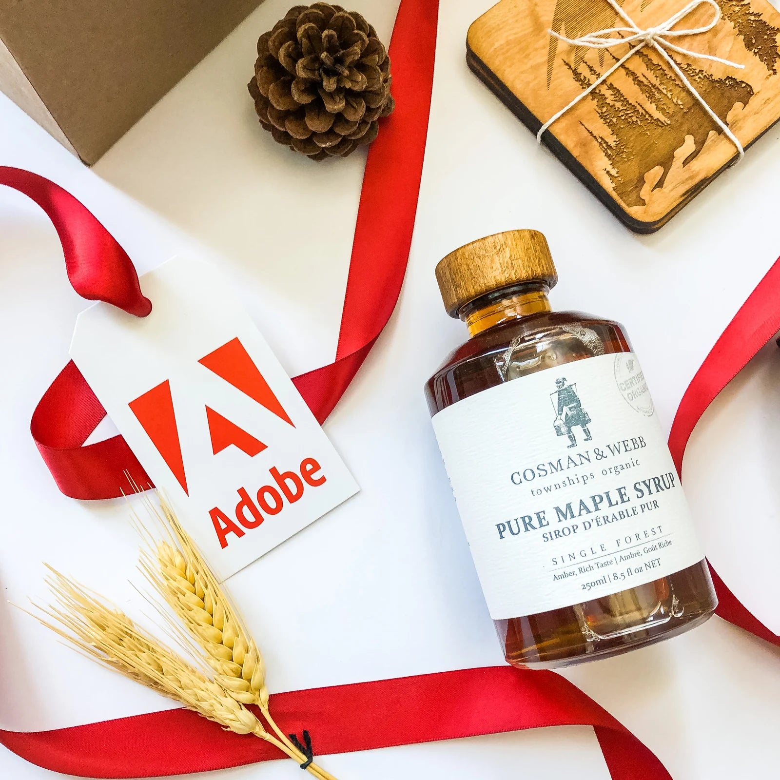 Adobe gift tag and red ribbon alongside selected gift products.