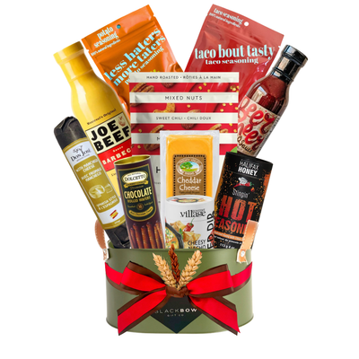 Bold Bites gourmet BBQ gift basket in an army green metal caddy with Joe Beef sauces, gourmet seasonings, cheese, nuts and chocolate treats.