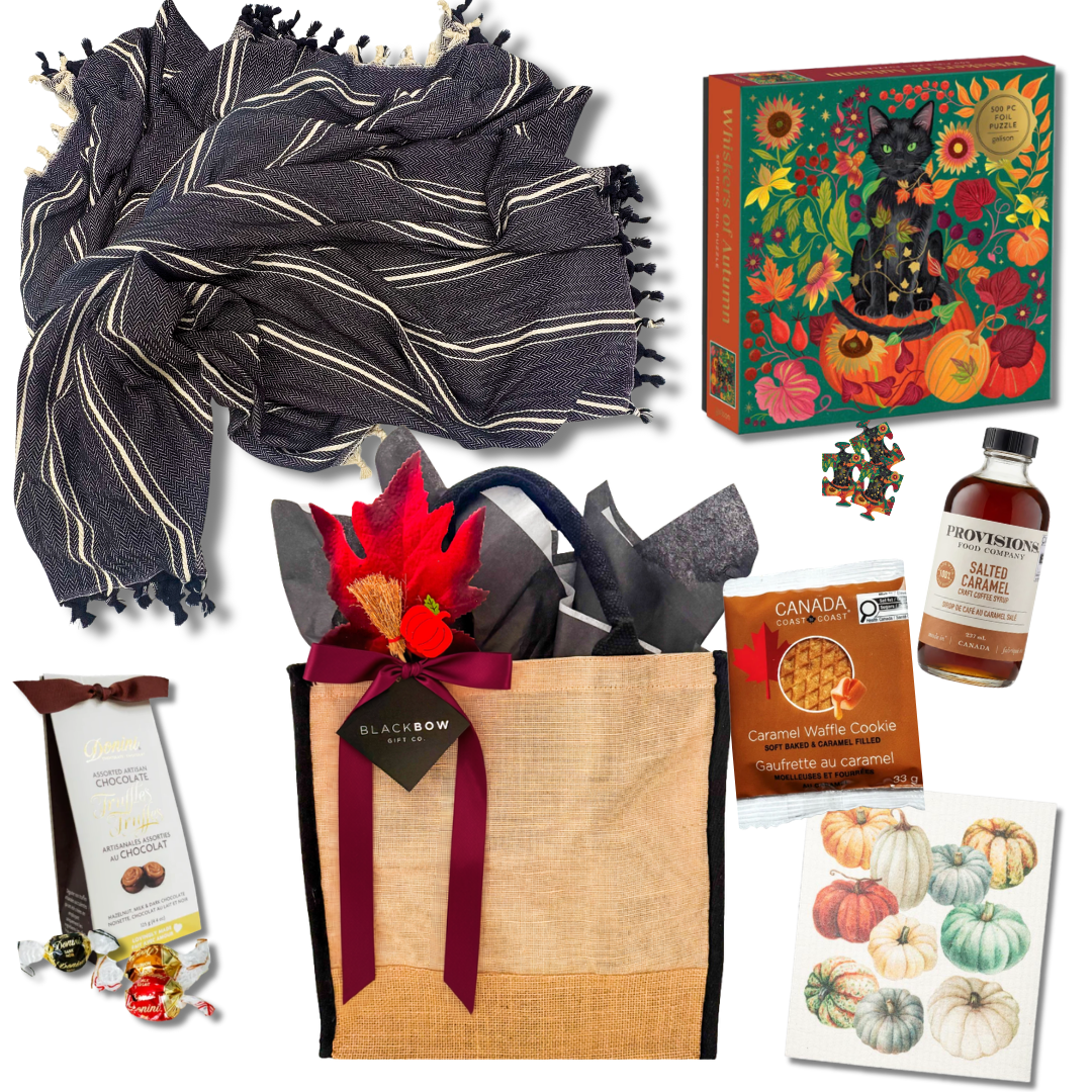 Fall at Home gift basket with cozy throw, fall puzzle, maple drink, chocolates and seasonal kitchen towel
