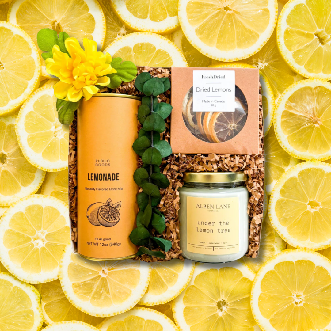 Gift set with lemonade, candle, and dried lemons on a background of lemon slices. Summer sale promotion highlighting discounted luxury gift boxes and everyday gifts with local Canadian gift delivery available nationwide.