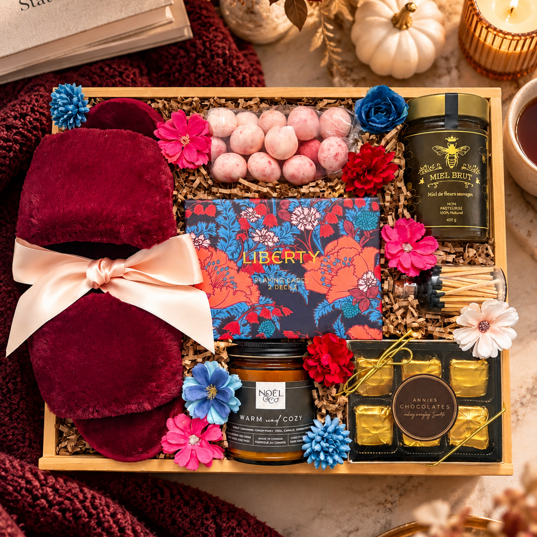 cozy fall gift with burgundy fuzzy slippers, cards, chocolates, candle, honey and mattes, perfectly presented in a wood gift box